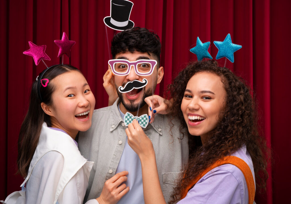 How To Turn Any Venue Into An Immersive Experience - posing in photo booth e1759906350500